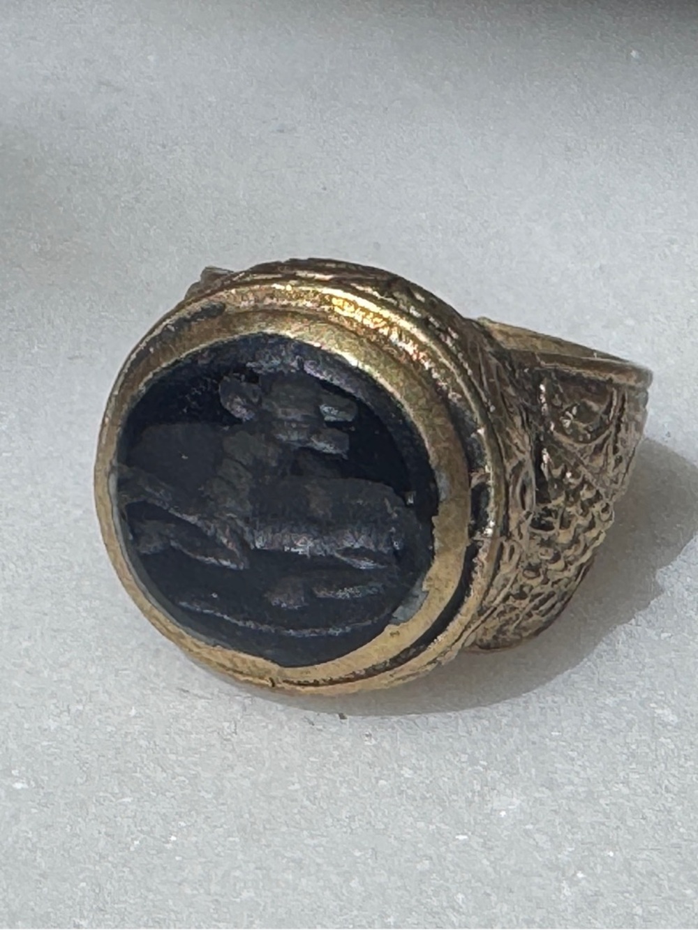 Black Carved Animal Signet Ring set in brass / gold tone band
